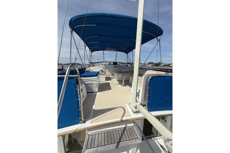 Slide: The Image of 1999 Grand Banks 42 Classic yacht deck with blue canopy and seating area. - 22