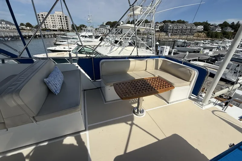 Slide: The Image of 1999 Grand Banks 42 Classic yacht with spacious deck seating and marina view. - 24