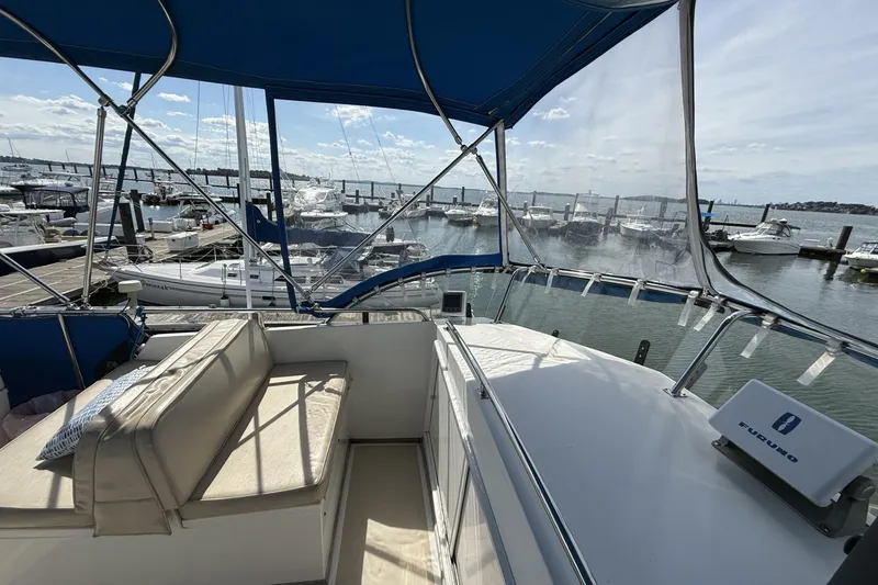 Slide: The Image of 1999 Grand Banks 42 Classic yacht with blue canopy, docked at marina. - 26