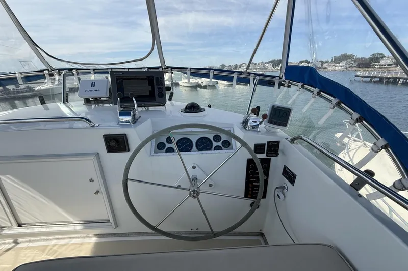 Slide: The Image of Cockpit of 1999 Grand Banks 42 Classic yacht with steering wheel and navigation equipment. - 27