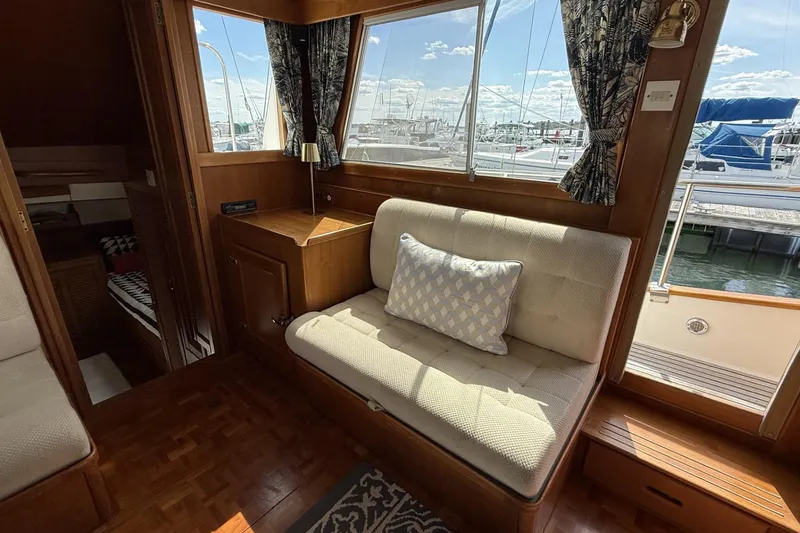 Slide: The Image of Interior of 1999 Grand Banks 42 Classic yacht with cozy seating and marina view. - 30