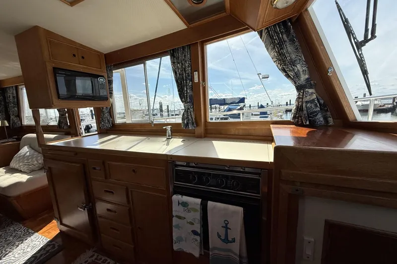Slide: The Image of Interior of 1999 Grand Banks 42 Classic yacht with kitchen and marina view. - 32