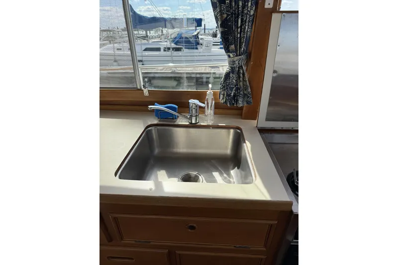 Slide: The Image of Stainless steel sink in 1999 Grand Banks 42 Classic yacht kitchen with marina view. - 34