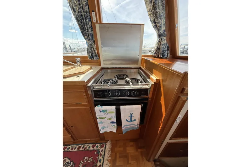 Slide: The Image of Galley kitchen in 1999 Grand Banks 42 Classic yacht with stove and nautical decor. - 36