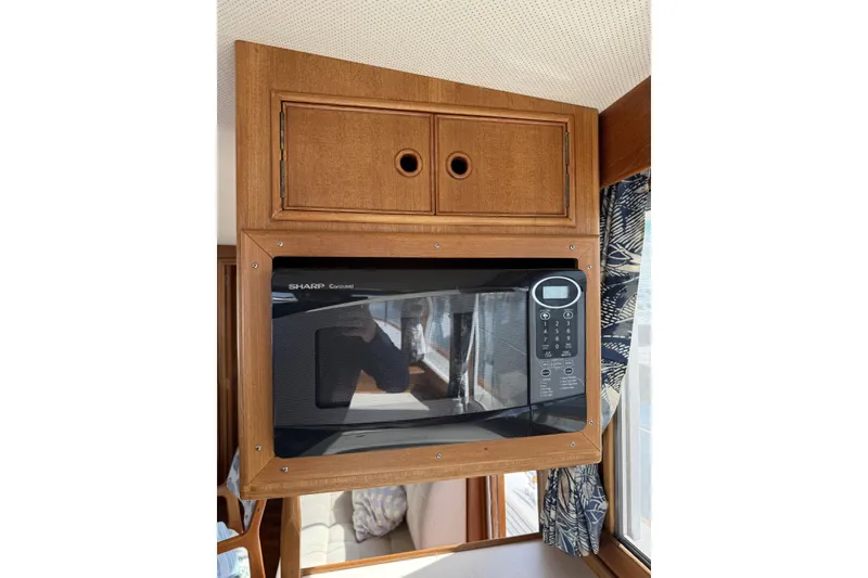 Slide: The Image of Microwave in 1999 Grand Banks 42 Classic yacht kitchen with wooden cabinetry. - 37