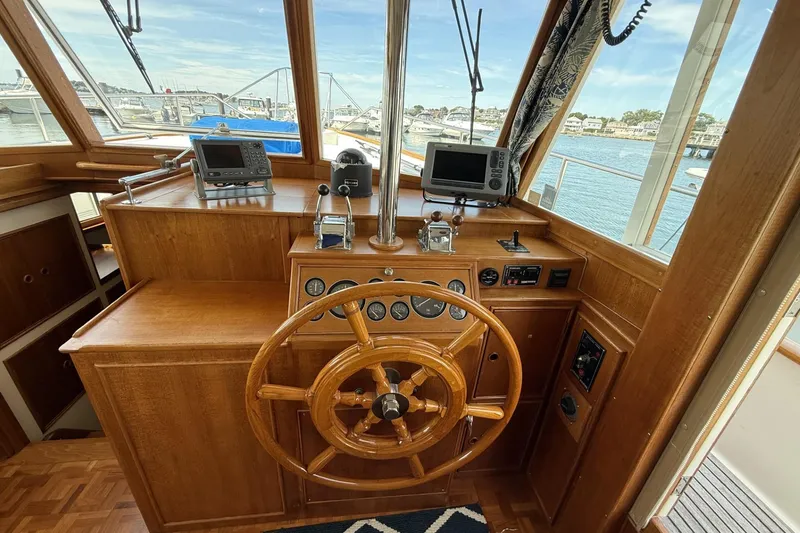 Slide: The Image of Helm of 1999 Grand Banks 42 Classic yacht with wooden wheel and navigation instruments. - 39