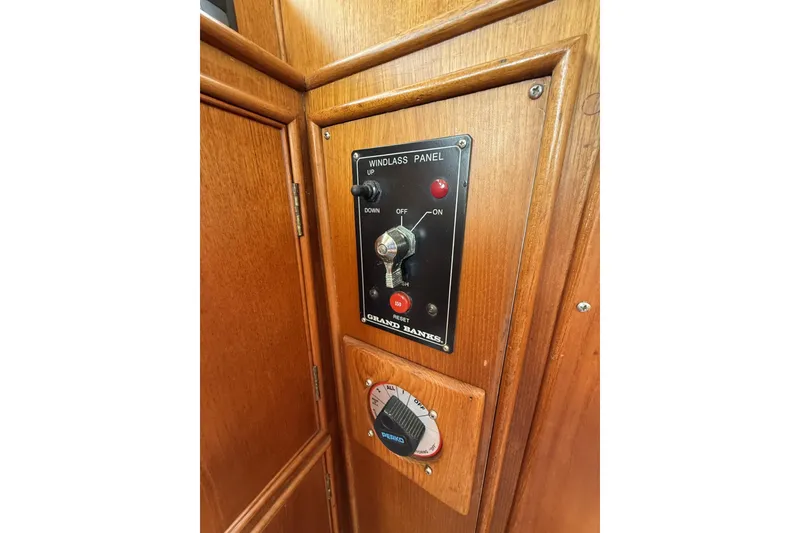 Slide: The Image of Windlass control panel on 1999 Grand Banks 42 Classic boat, featuring wooden interior. - 42