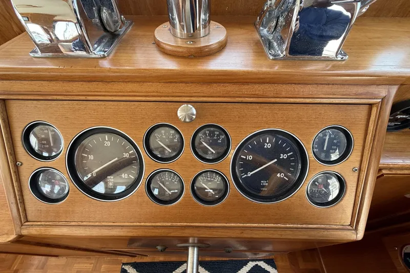 Slide: The Image of Dashboard of a 1999 Grand Banks 42 Classic boat with various gauges and controls. - 43