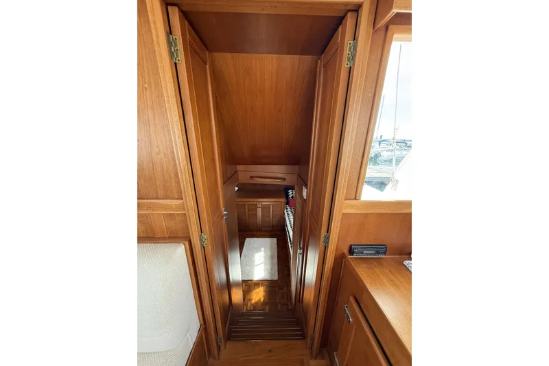Slide: The Image of Interior of 1999 Grand Banks 42 Classic yacht with wooden cabinetry and stairs. - 45