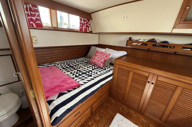 Slide: The Image of Cozy cabin interior of 1999 Grand Banks 42 Classic yacht with bed and wooden cabinetry. - 47