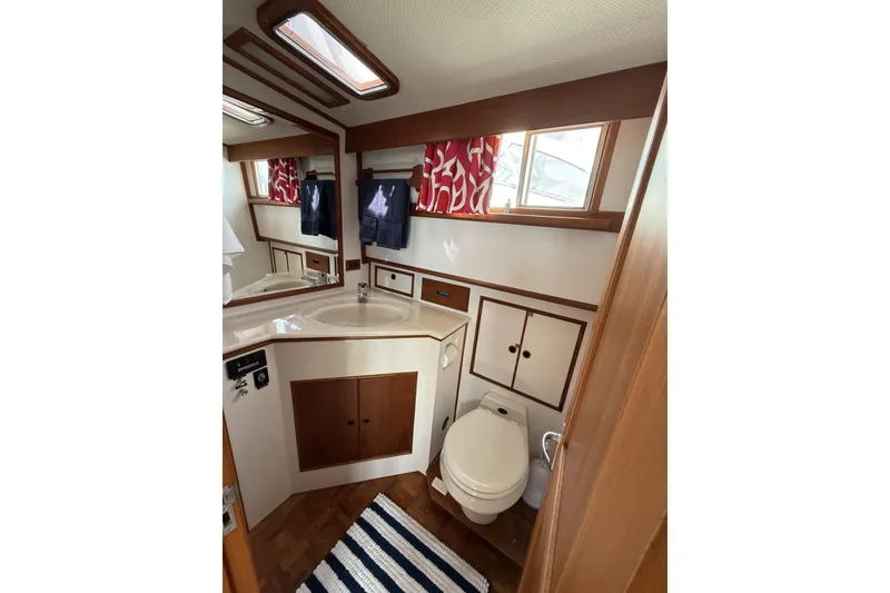 Slide: The Image of Bathroom interior of 1999 Grand Banks 42 Classic yacht with wood accents and nautical decor. - 52