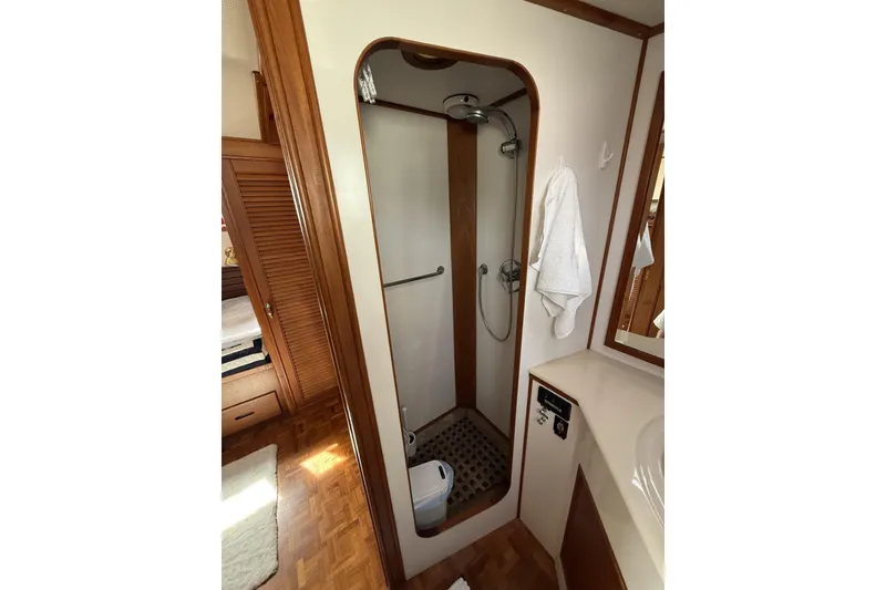 Slide: The Image of Shower area in 1999 Grand Banks 42 Classic yacht, featuring wooden accents and compact design. - 53