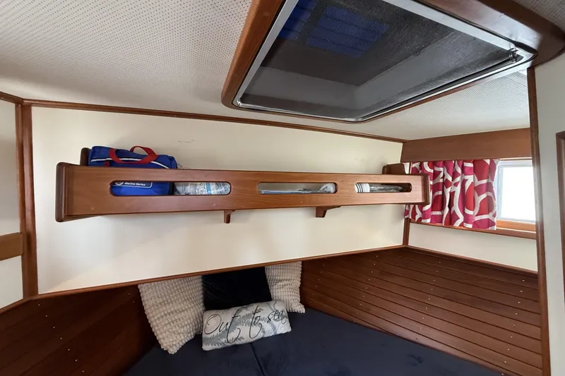 Slide: The Image of 1999 Grand Banks 42 Classic cabin interior with wooden shelves and nautical decor. - 56