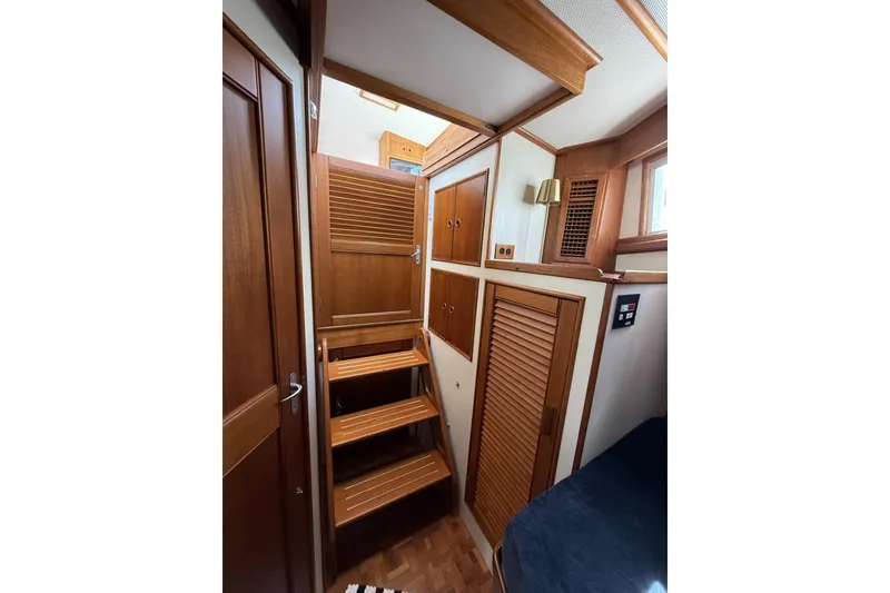 Slide: The Image of Interior of 1999 Grand Banks 42 Classic yacht with wooden stairs and cabinetry. - 57