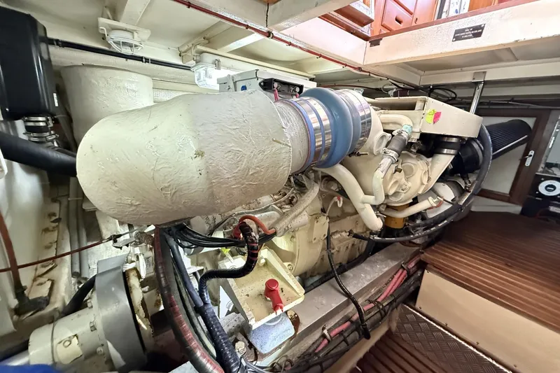 Slide: The Image of Engine room of 1999 Grand Banks 42 Classic yacht, showcasing detailed machinery and components. - 60