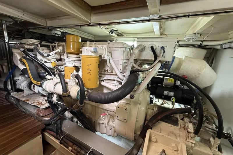 Slide: The Image of Engine room of a 1999 Grand Banks 42 Classic yacht, showcasing complex machinery and components. - 61