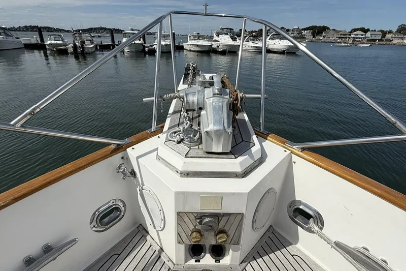 Slide: The Image of Bow view of 1999 Grand Banks 42 Classic yacht at marina, featuring anchor winch. - 8