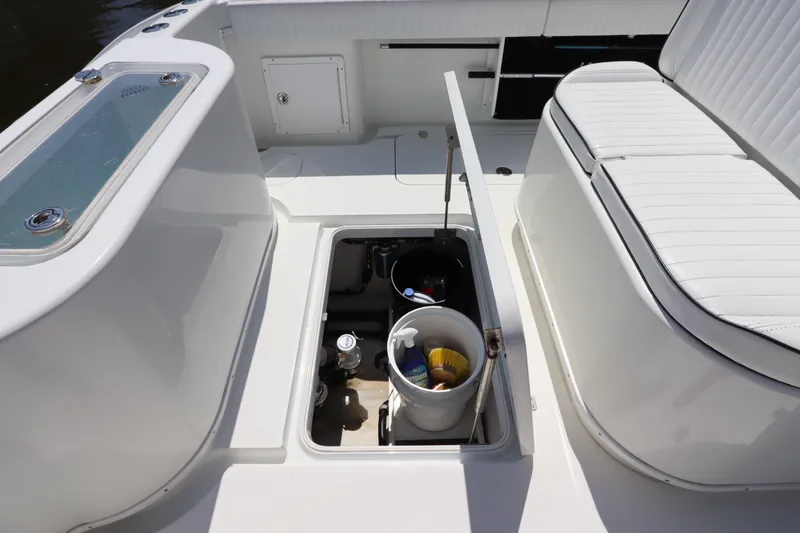 Slide: The Image of 2013 Yellowfin 32 Offshore boat interior with storage compartment and seating. - 11