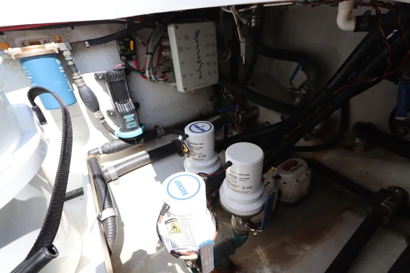 Slide: The Image of Engine compartment of a 2013 Yellowfin 32 Offshore boat, showing pumps and wiring. - 12