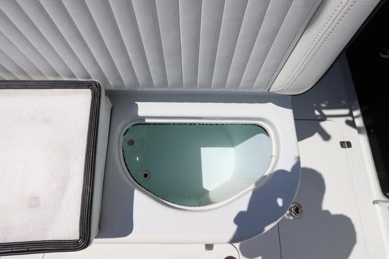 Slide: The Image of Livewell on 2013 Yellowfin 32 Offshore boat, featuring cushioned seating. - 15
