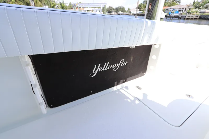 Slide: The Image of 2013 Yellowfin 32 Offshore boat interior with logo, featuring white and black design. - 20
