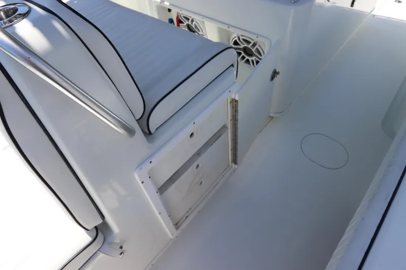 Slide: The Image of 2013 Yellowfin 32 Offshore boat interior with white seating and storage compartments. - 22