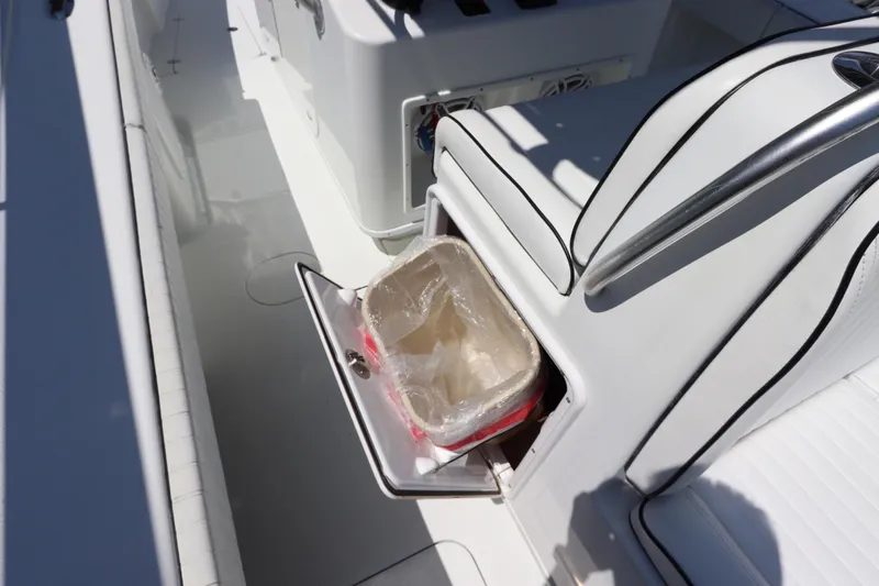 Slide: The Image of 2013 Yellowfin 32 Offshore boat interior with open storage compartment. - 24
