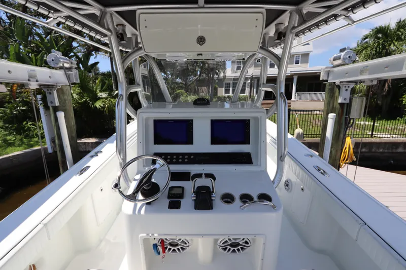 Slide: The Image of 2013 Yellowfin 32 Offshore boat cockpit with dual screens and steering wheel. - 26