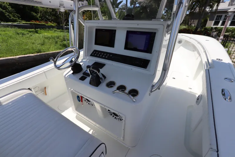 Slide: The Image of 2013 Yellowfin 32 Offshore boat cockpit with steering wheel and control panel. - 27