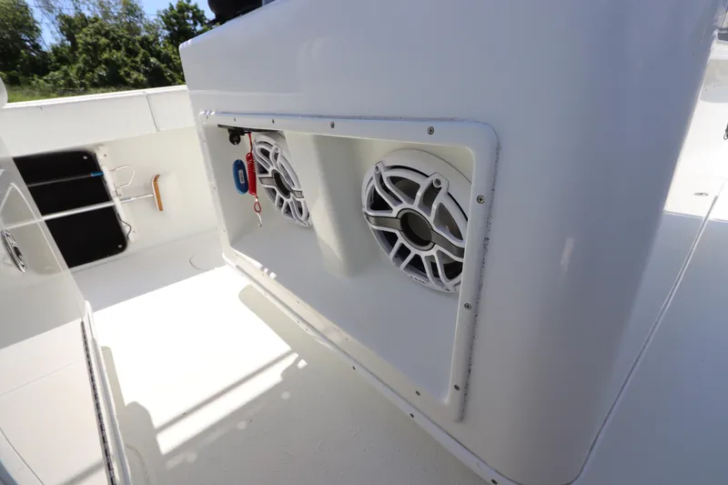 Slide: The Image of 2013 Yellowfin 32 Offshore boat interior with speakers and clean white deck. - 28