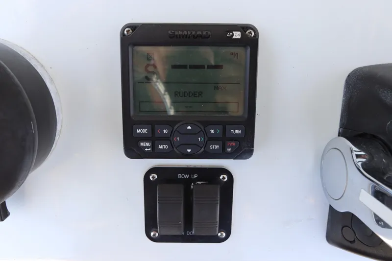 Slide: The Image of Simrad AP24 control panel on 2013 Yellowfin 32 Offshore boat dashboard. - 31