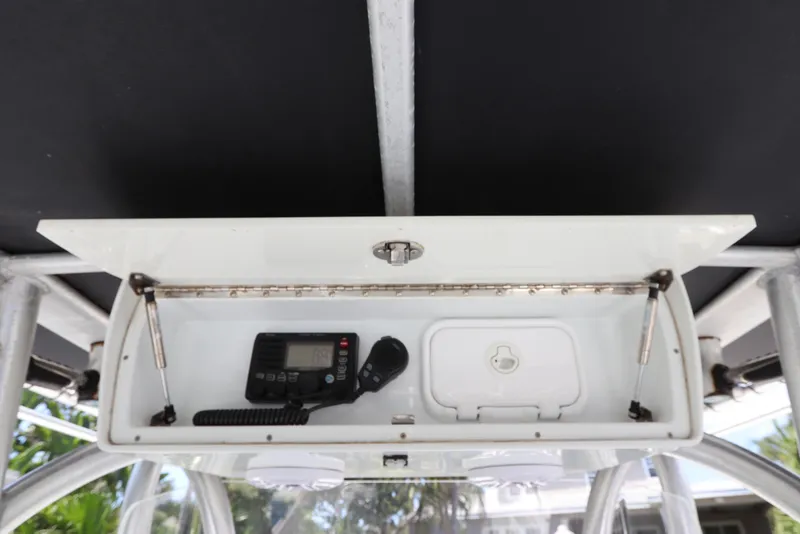 Slide: The Image of 2013 Yellowfin 32 Offshore boat console with radio equipment and storage compartment. - 35