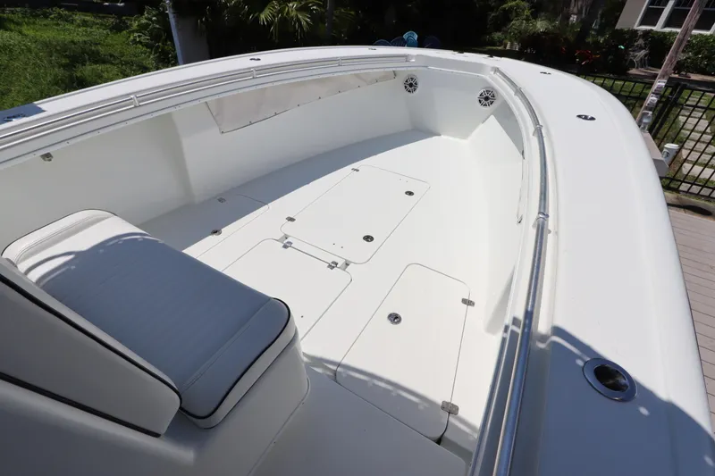 Slide: The Image of 2013 Yellowfin 32 Offshore boat interior with white seating and storage compartments. - 37