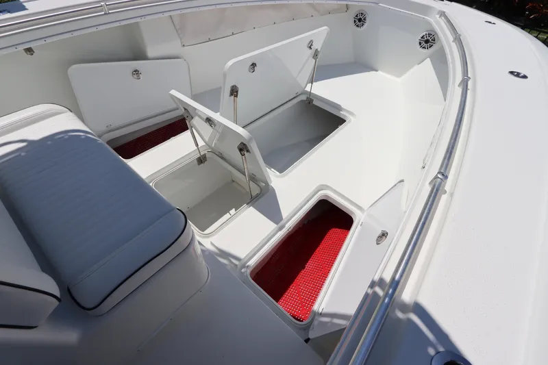 Slide: The Image of 2013 Yellowfin 32 Offshore boat with open storage compartments and seating area. - 38