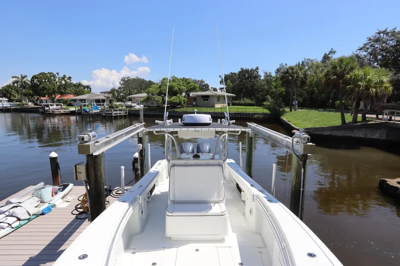 Slide: The Image of 2013 Yellowfin 32 Offshore boat docked in a scenic waterfront setting. - 42