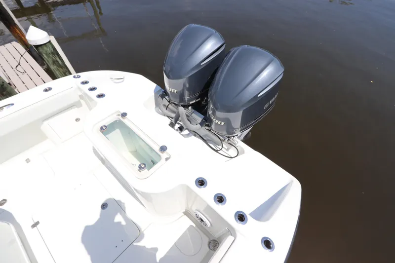 Slide: The Image of 2013 Yellowfin 32 Offshore boat with dual outboard engines docked by water. - 9
