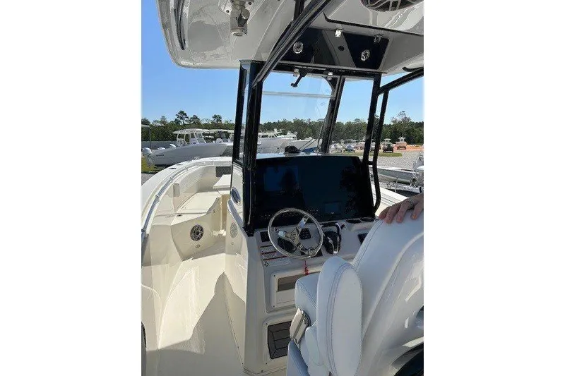 Slide: The Image of 2023 Cobia 280 Center Console boat interior with steering wheel and navigation display. - 3