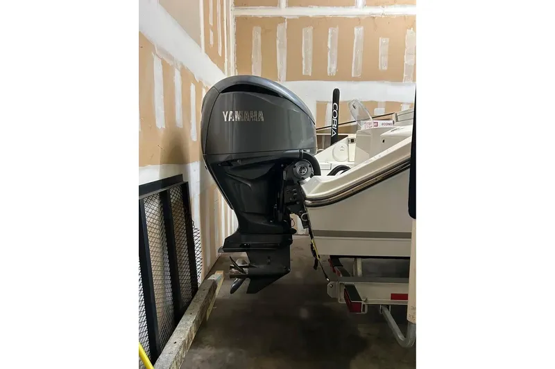 Slide: The Image of 2023 Cobia 280 Center Console with Yamaha outboard engine in garage. - 4