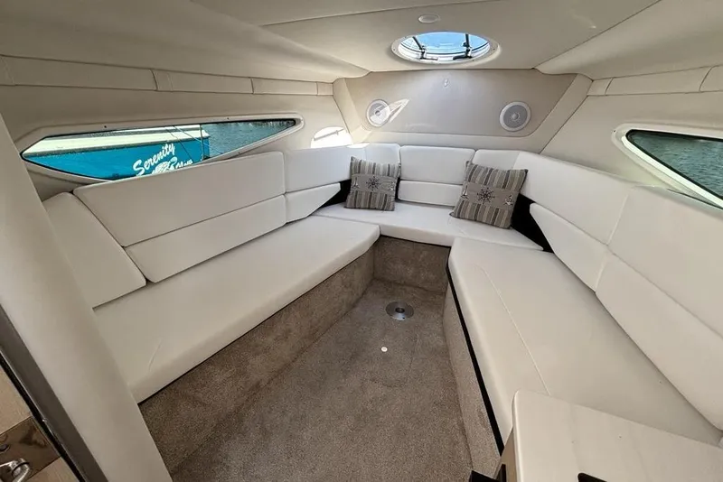 Slide: The Image of 2023 Regal 26 XO boat interior with white seating and decorative pillows. - 17