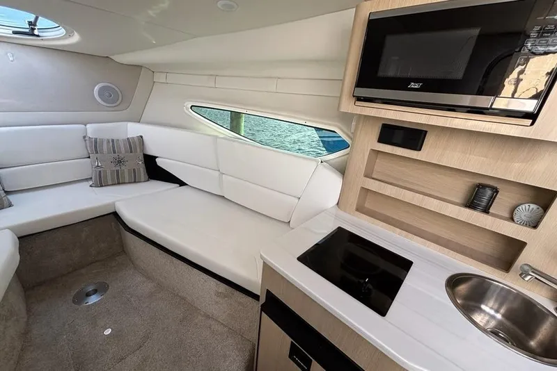 Slide: The Image of 2023 Regal 26 XO cabin interior with kitchenette, seating, and modern amenities. - 18