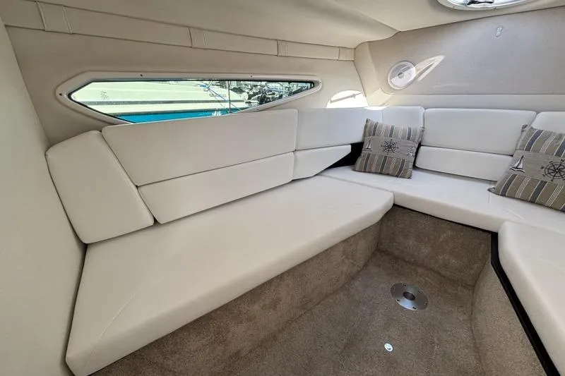 Slide: The Image of Luxurious interior of 2023 Regal 26 XO boat with plush seating and nautical-themed pillows. - 20