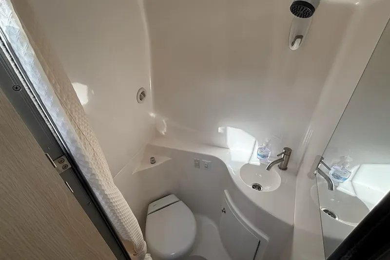Slide: The Image of 2023 Regal 26 XO boat bathroom with shower, sink, and toilet. - 25