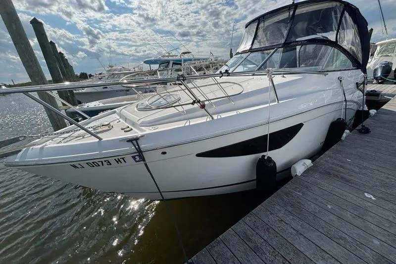 Slide: The Image of 2023 Regal 26 XO boat docked at marina under cloudy sky. - 3