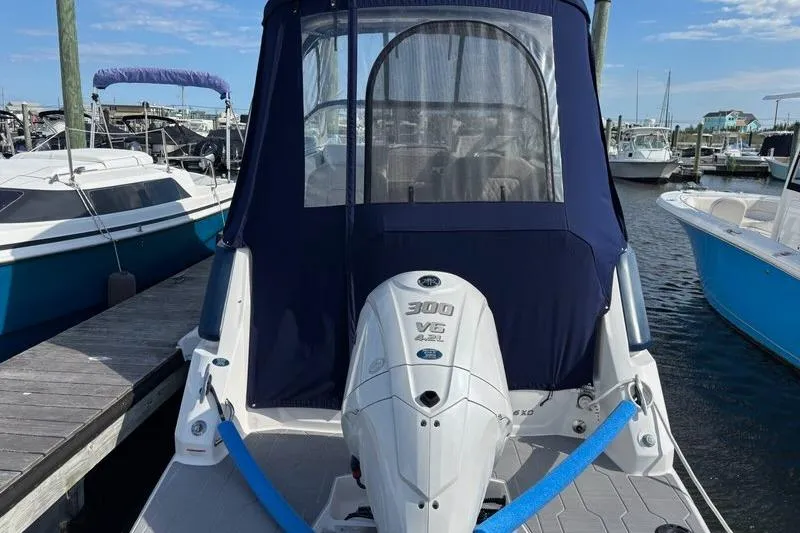 Slide: The Image of 2023 Regal 26 XO boat with Yamaha 300 V6 engine docked at marina. - 4