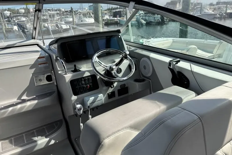 Slide: The Image of 2023 Regal 26 XO boat cockpit with steering wheel and control panel. - 6