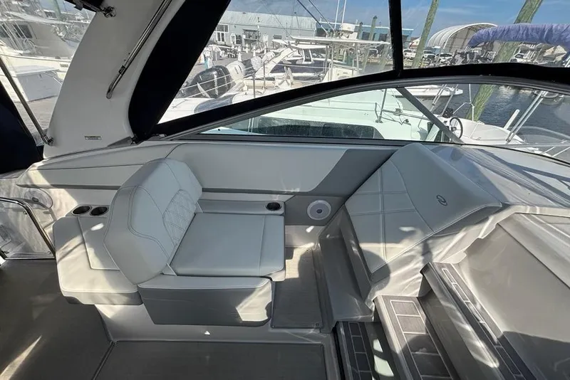Slide: The Image of 2023 Regal 26 XO boat interior with white seating and marina view. - 8