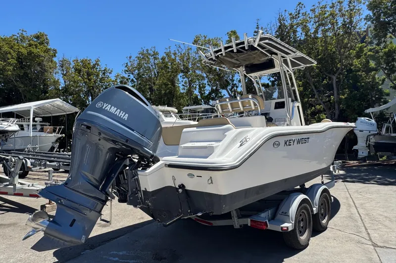 Slide: The Image of 2019 Key West 239 FS boat with Yamaha engine on trailer, parked outdoors. - 10