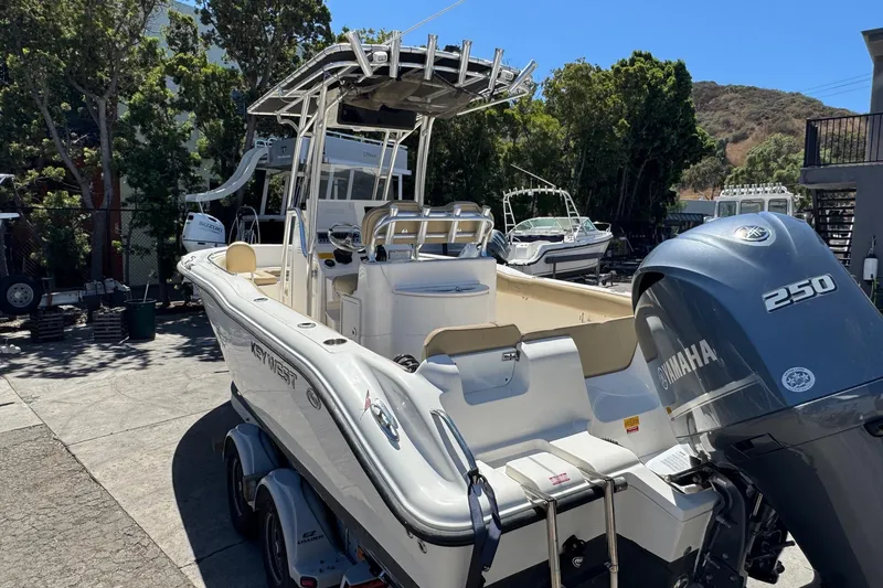 Slide: The Image of 2019 Key West 239 FS boat with Yamaha 250 engine, parked outdoors. - 16
