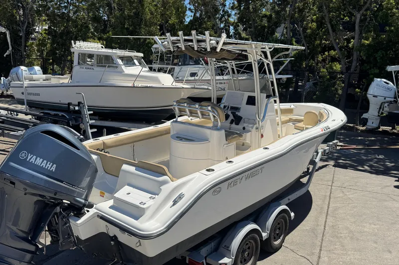 Slide: The Image of 2019 Key West 239 FS boat with Yamaha engine on trailer, surrounded by other boats. - 17