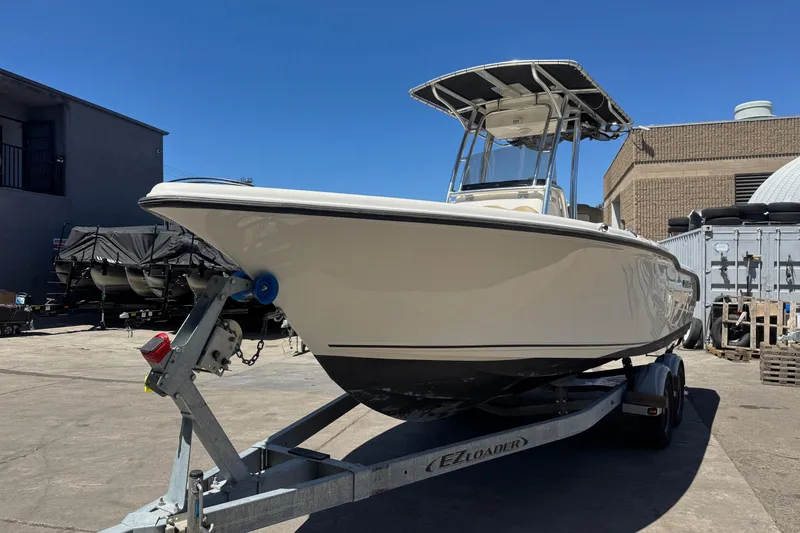 Slide: The Image of 2019 Key West 239 FS boat on trailer in industrial setting. - 4